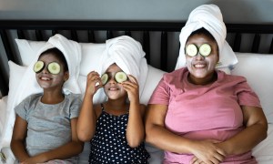 Mother and daughters in bed having a spa day