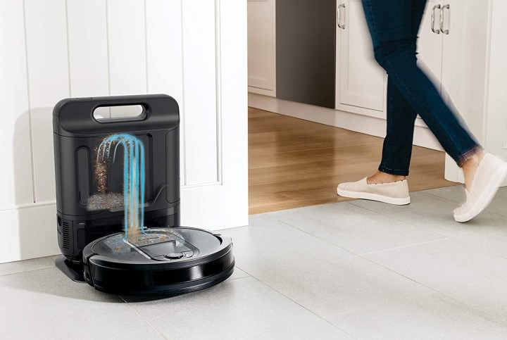 Person walking by Shark IQ self emptying robot vacuum on docking station