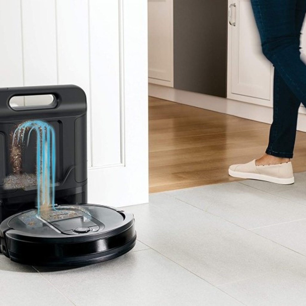 Person walking by Shark IQ self emptying robot vacuum on docking station