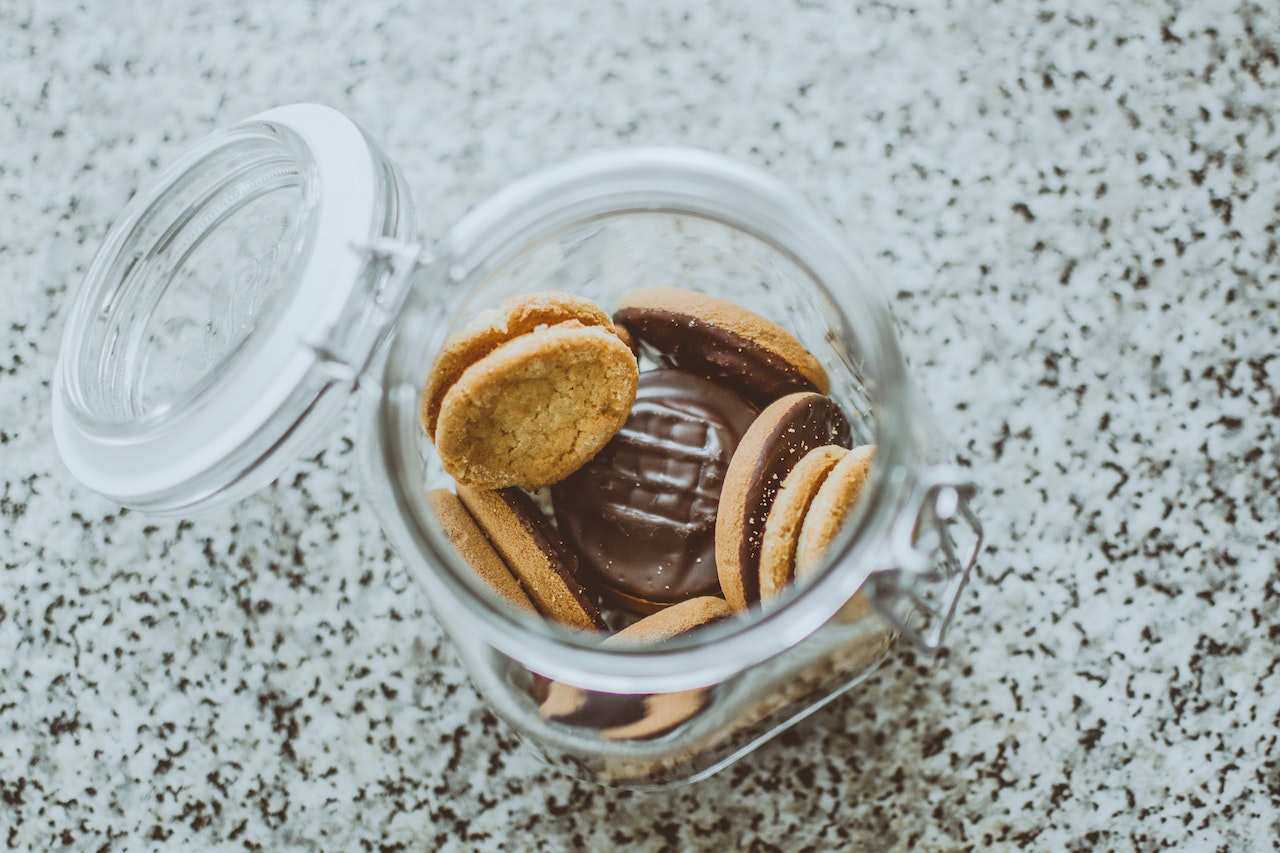 chocolate peanut butter cookies in a clear cookie jar