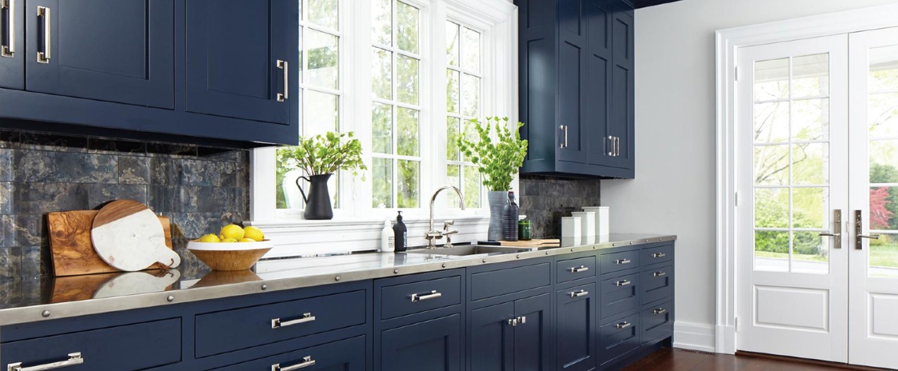 Kitchen with navy blue cabinets and brass hardware