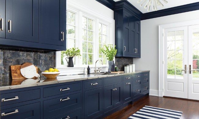 Kitchen with navy blue cabinets and brass hardware