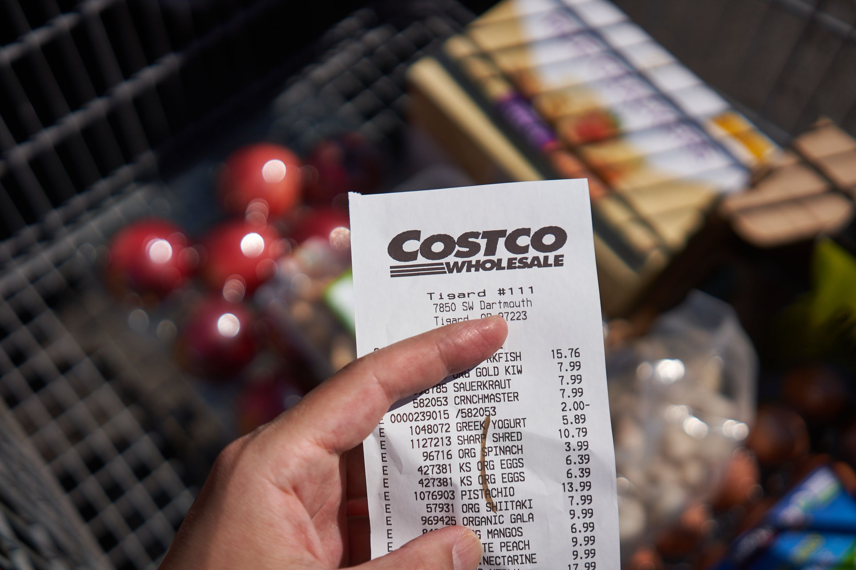 person holding costco receipt