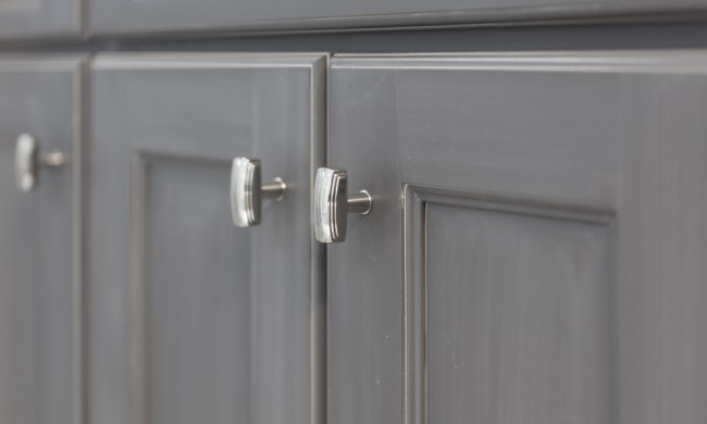 Gray shaker-style cabinets with chrome hardware