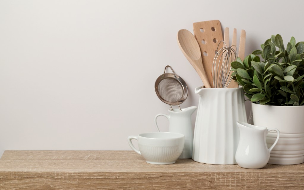 Containers of utensils on a kitchen counter