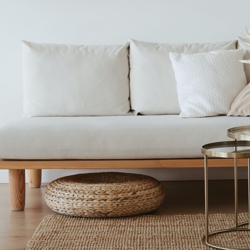 Minimal white living room with wicker basket and bamboo rug