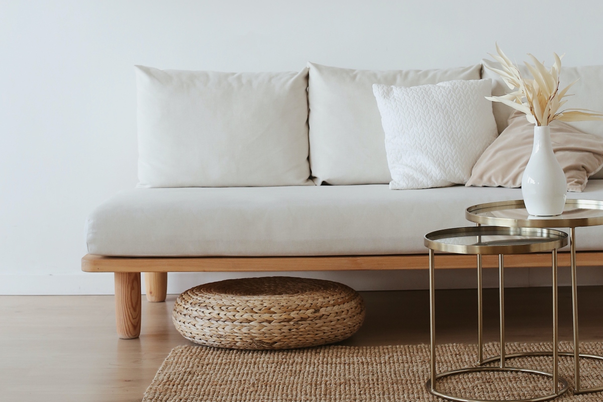 Minimal white living room with wicker basket and bamboo rug