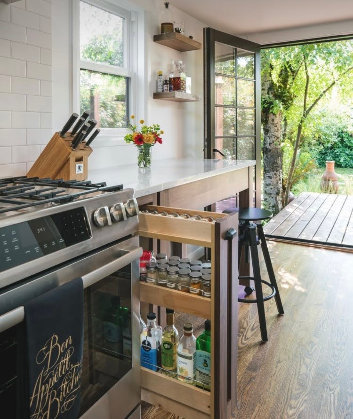 Custom pull-out spice rack in kitchen
