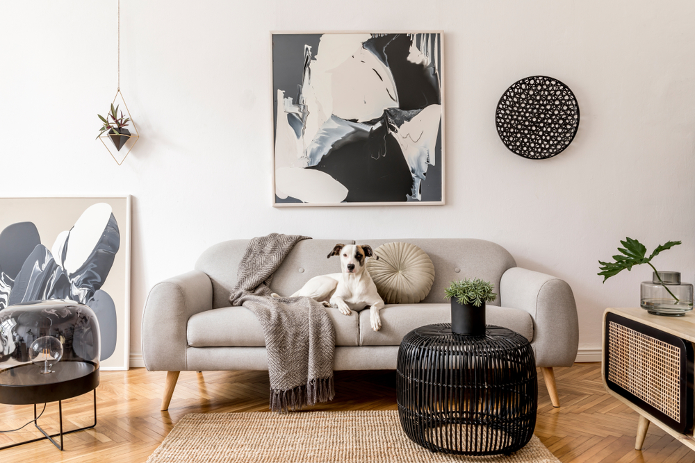 Modern living room with large painting hanging behind the couch