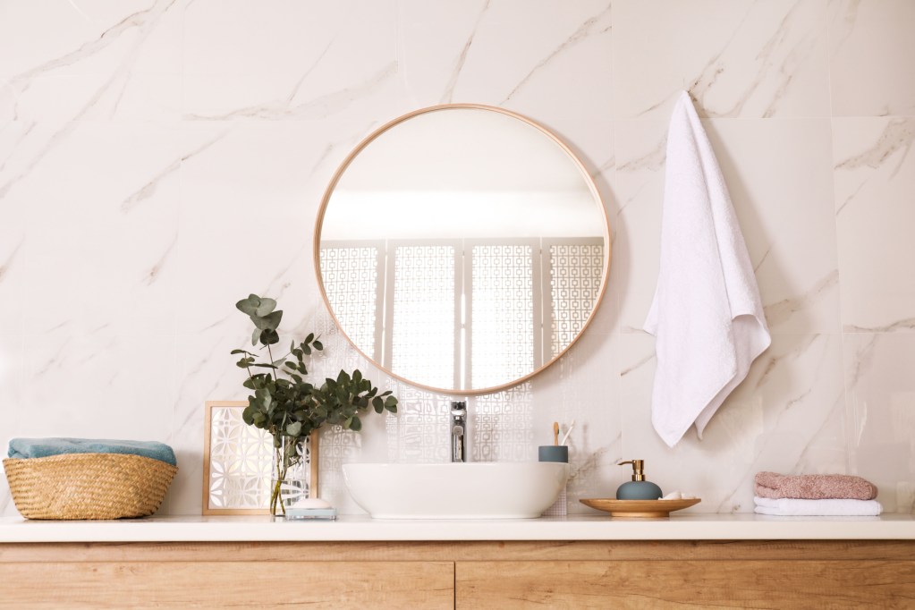 modern bathroom with round mirror