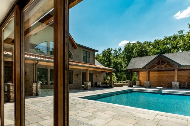 Backyard pool with pool house on the side