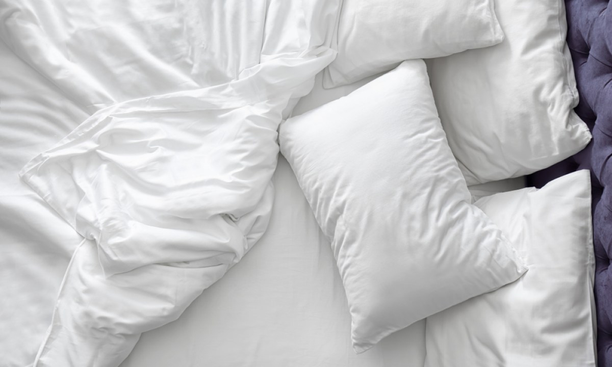 Top view of bed with white sheets