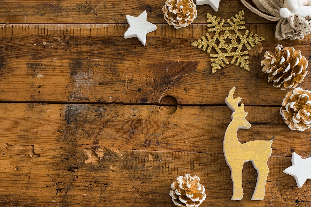 Wooden reindeer ornament on a wood surface