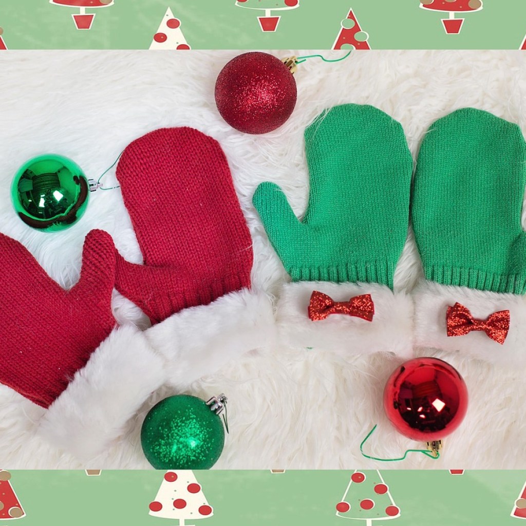 Red and green holiday mittens on a festive surface