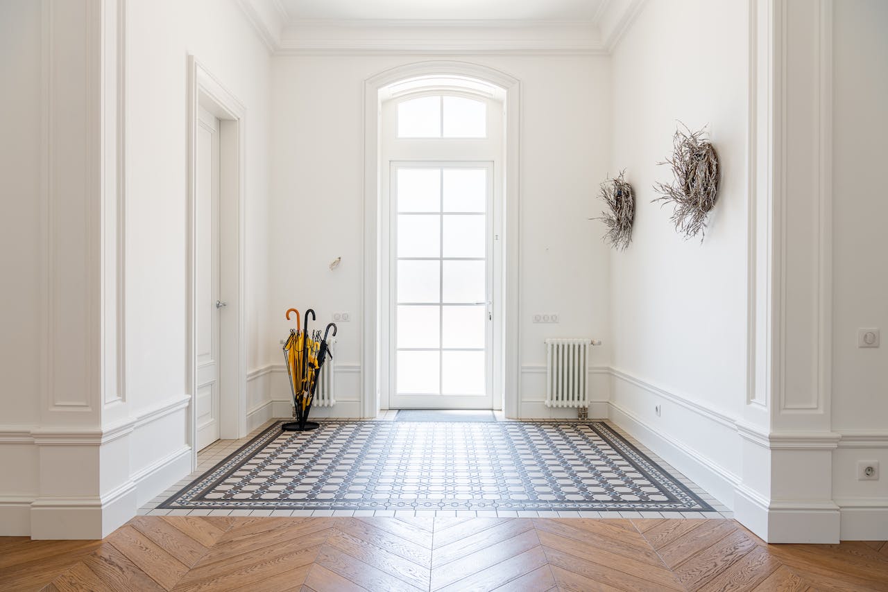 bright foyer with large window and white walls