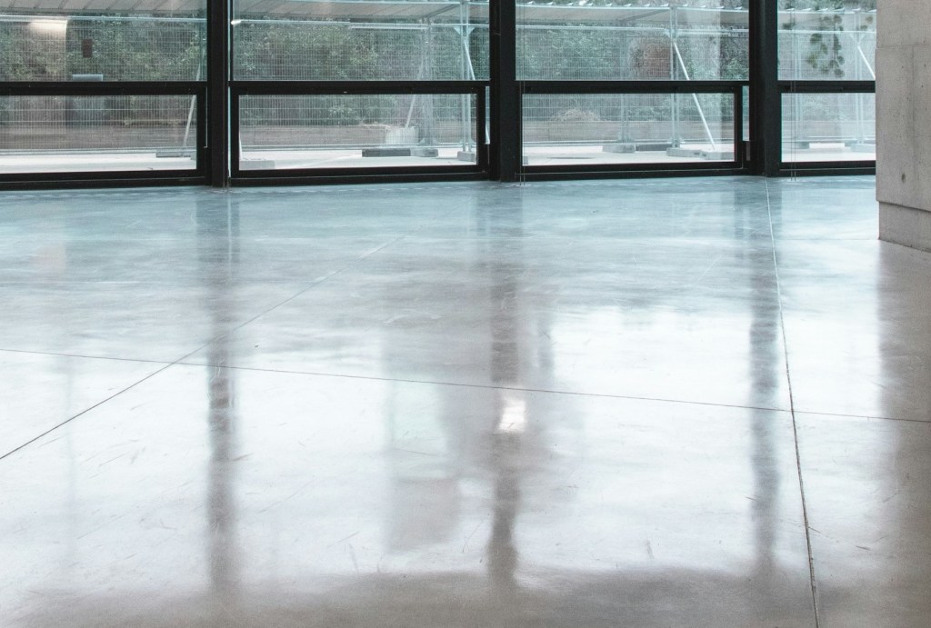 polished concrete floor against large bay windows