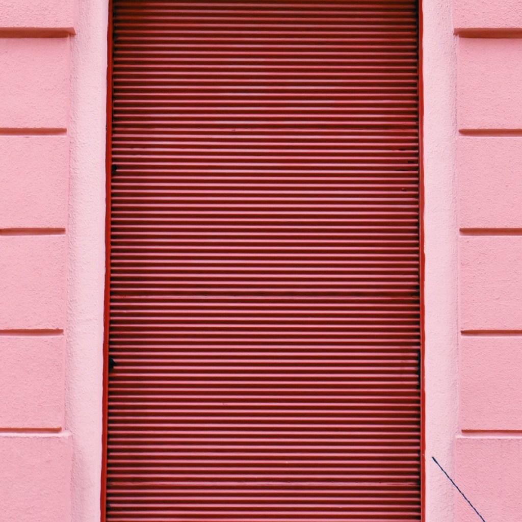 pink siding around a window with pink blinds