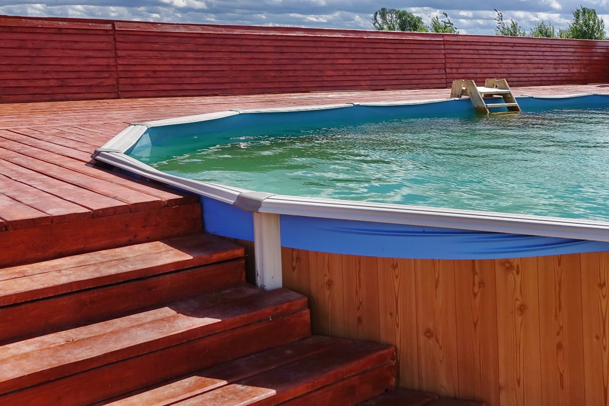 Above-ground pool with deck and stairs