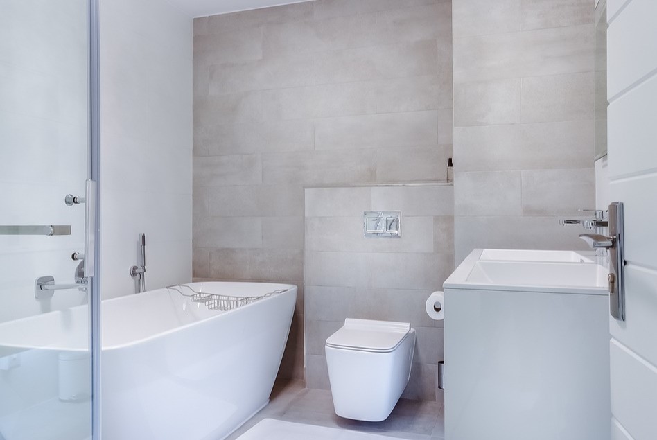 Modern minimalist bathroom with soaking tub and square toilet