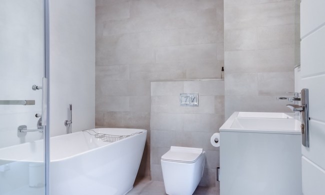 Modern minimalist bathroom with soaking tub and square toilet