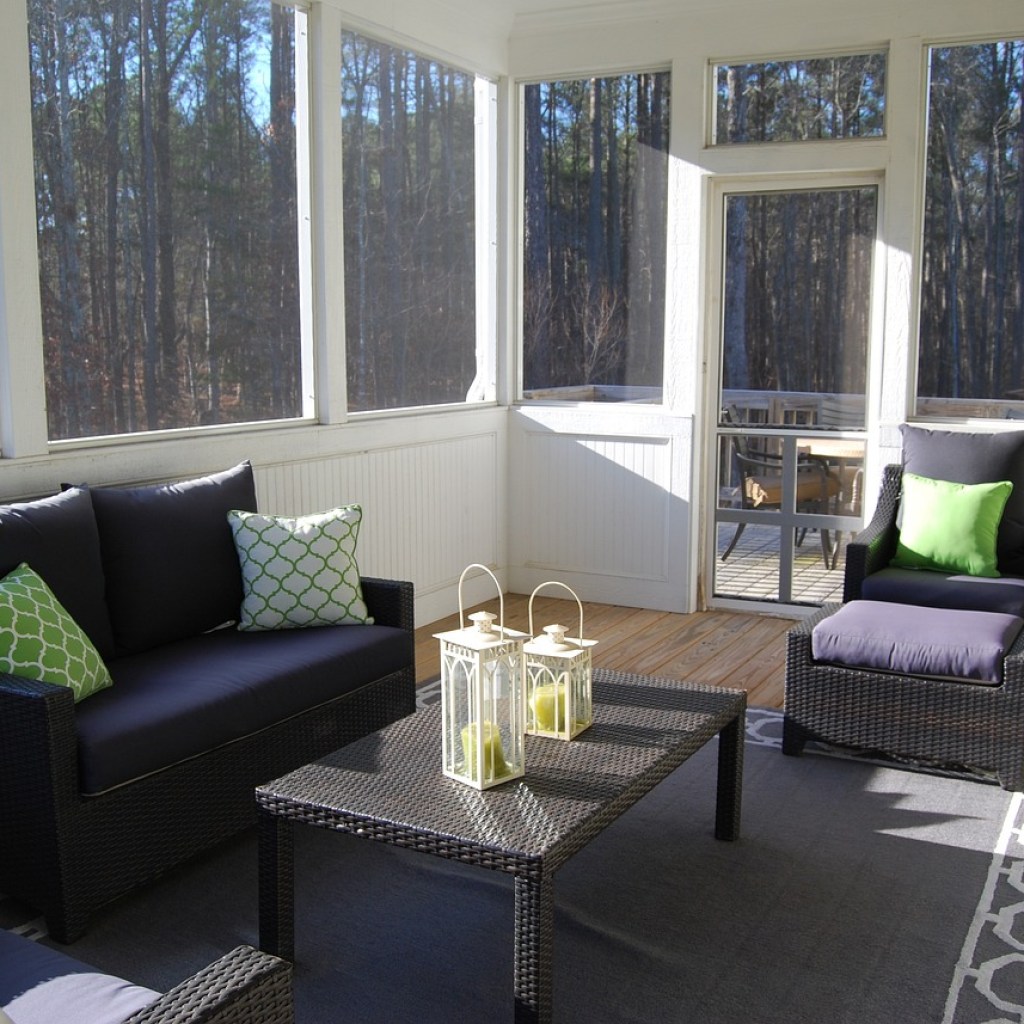 sunroom porch with dark furniture and white trim