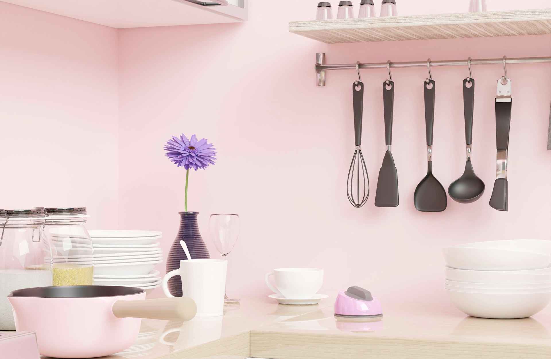 Pink kitchen wall with black and white utensils
