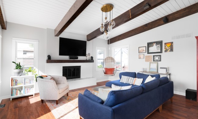 modern coastal all white living room with blue sofa and beadboard ceilings