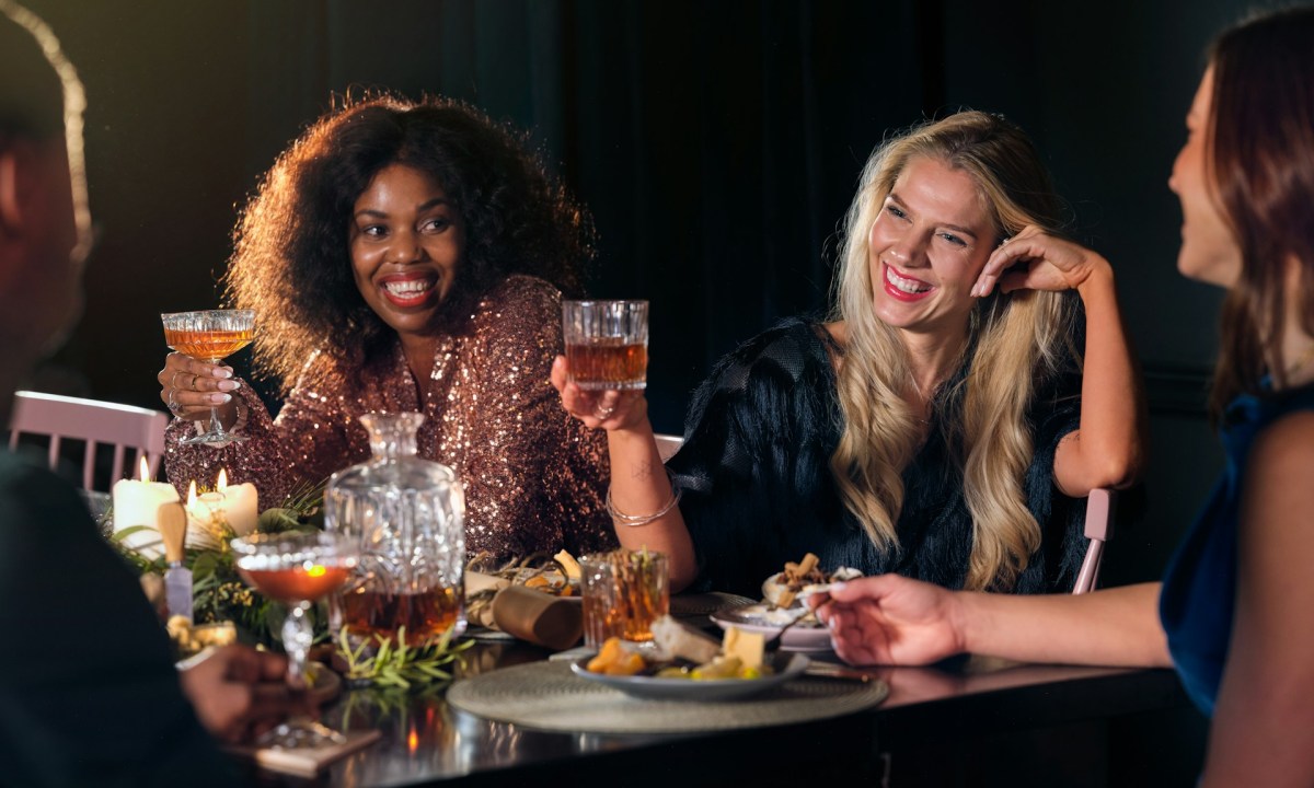 Friends having a dinner party with cocktails