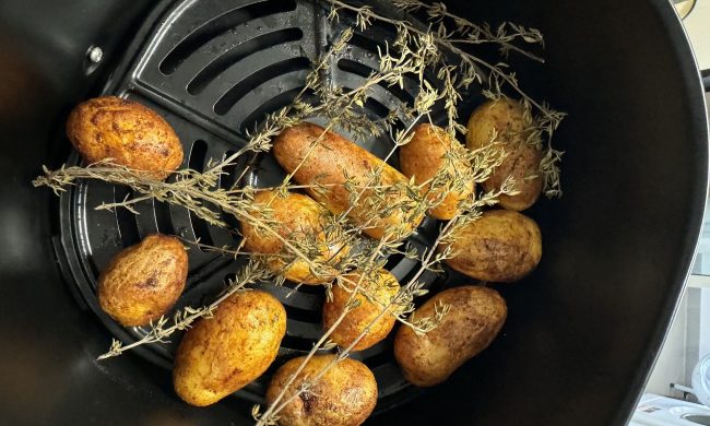 Potatoes and rosemary in an air fryer
