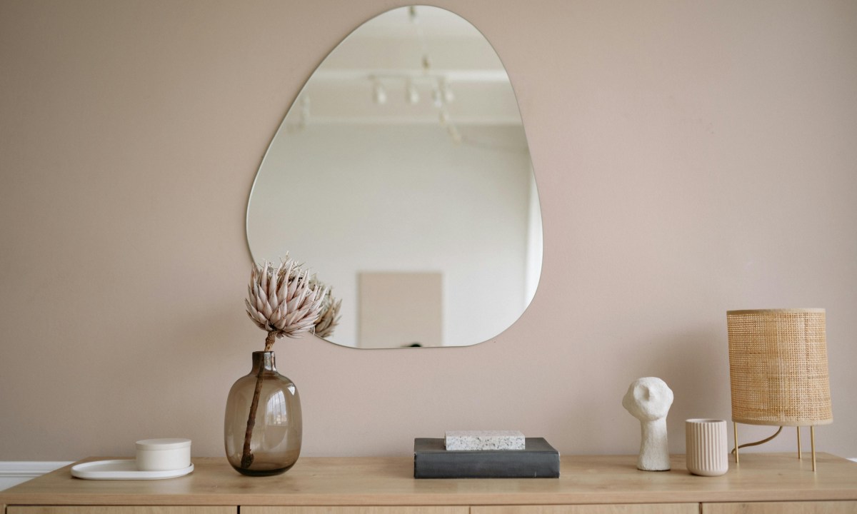taupe walls in entryway with mirror and table