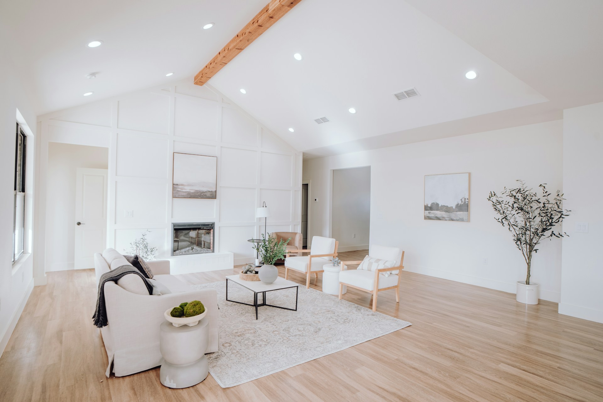White, bright living room with vaulted ceiling