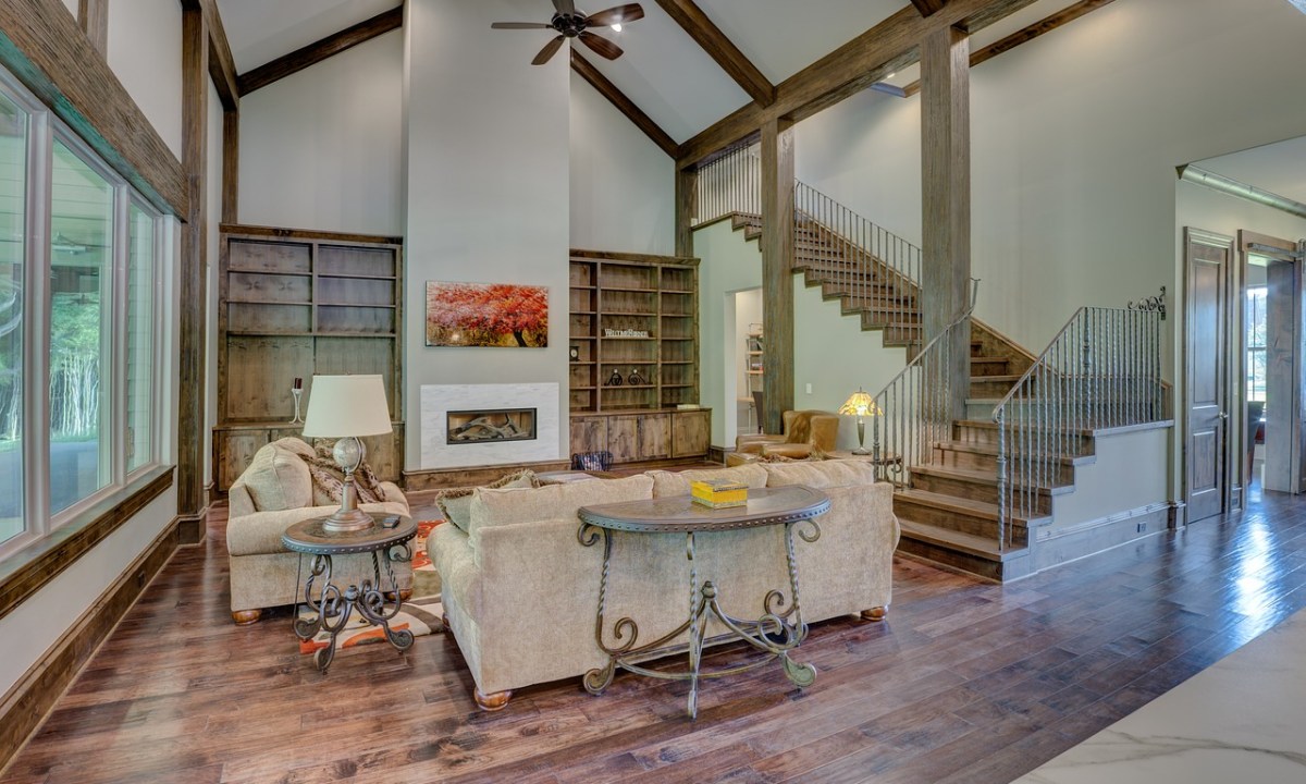 Living room with a vaulted ceiling and rustic wood floors