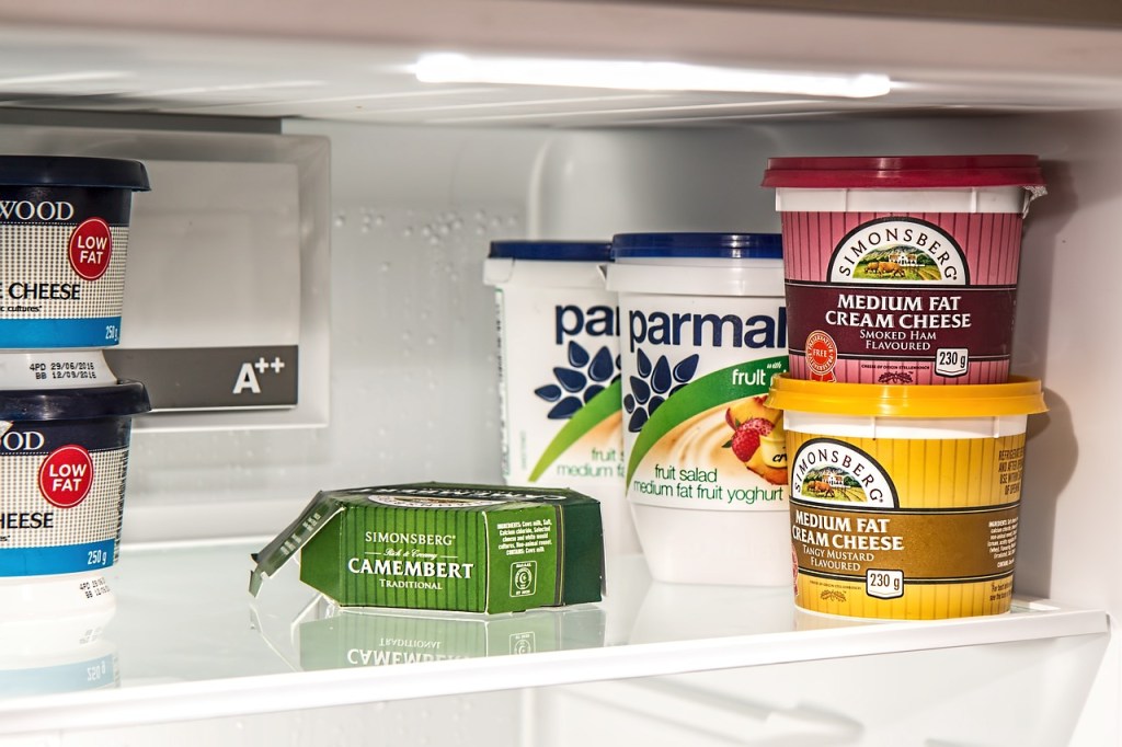 Yogurt and other items on fridge shelf