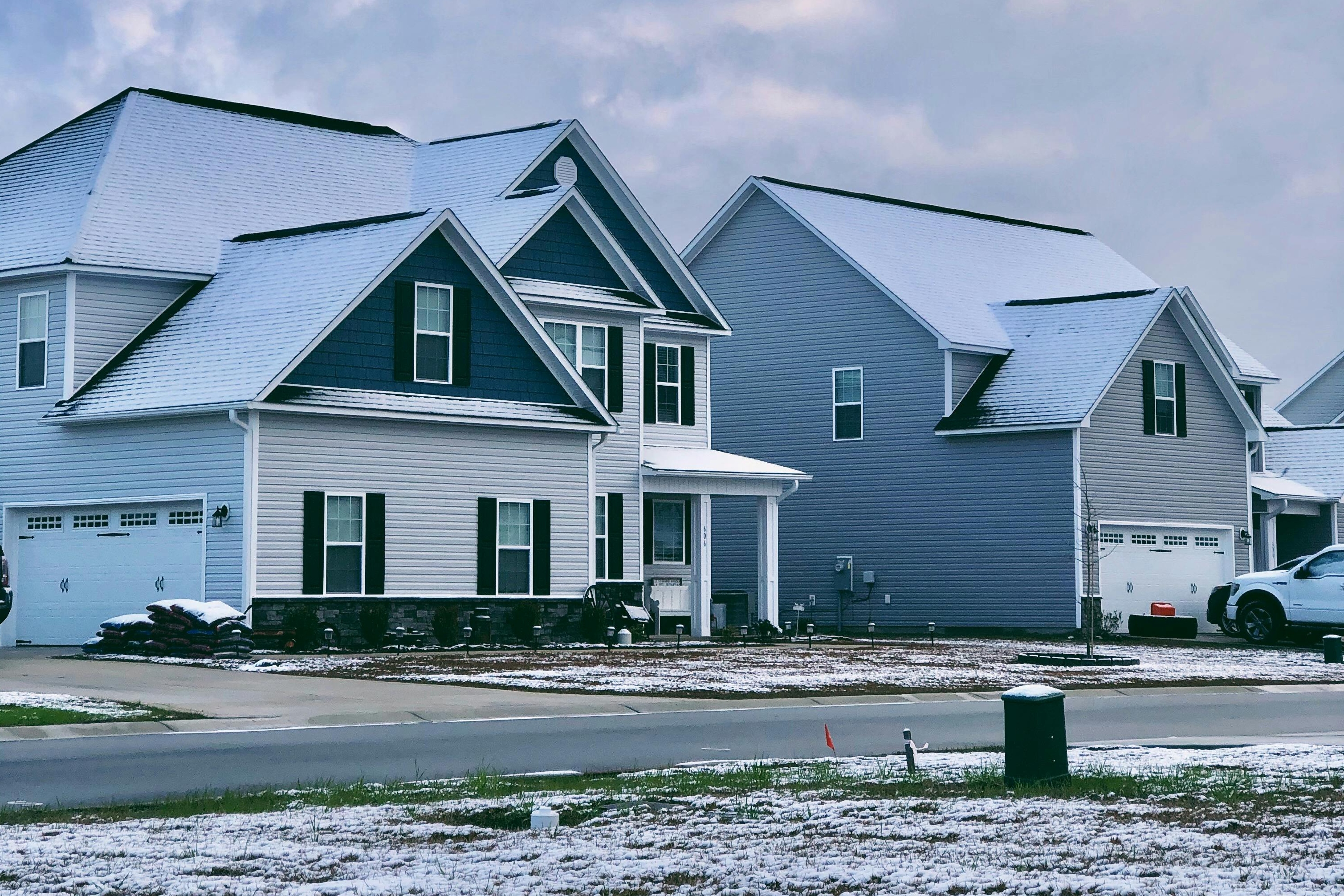 snowy house exterior with driveway