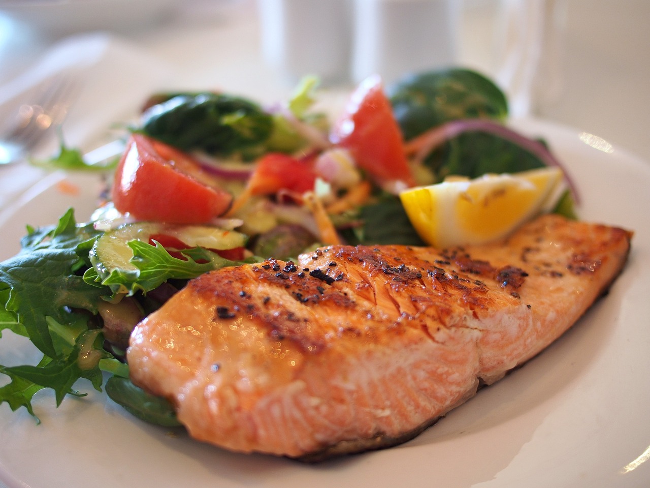 Salmon and veggies on a white plate