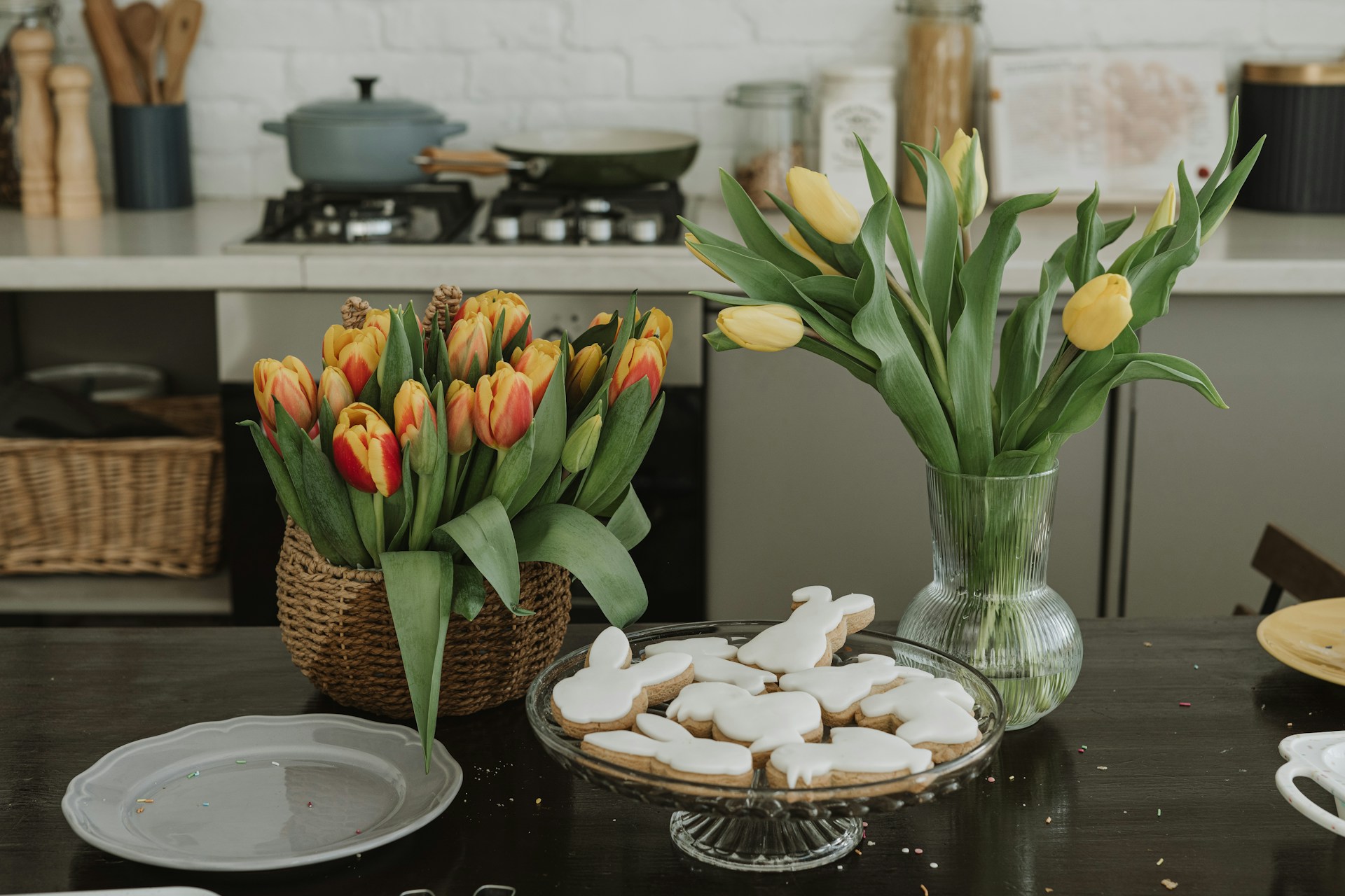 Vases with spring flowers in front of easter bunny cookies