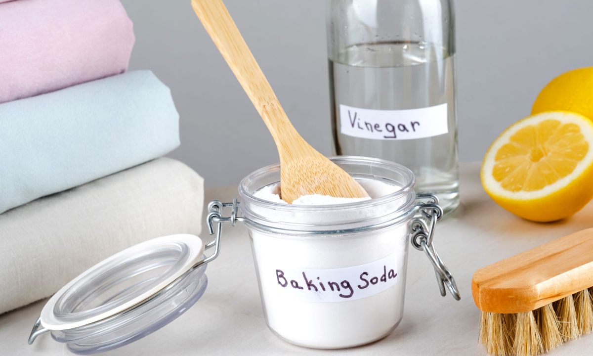 Clear glass containers of baking soda and vinegar in laundry area